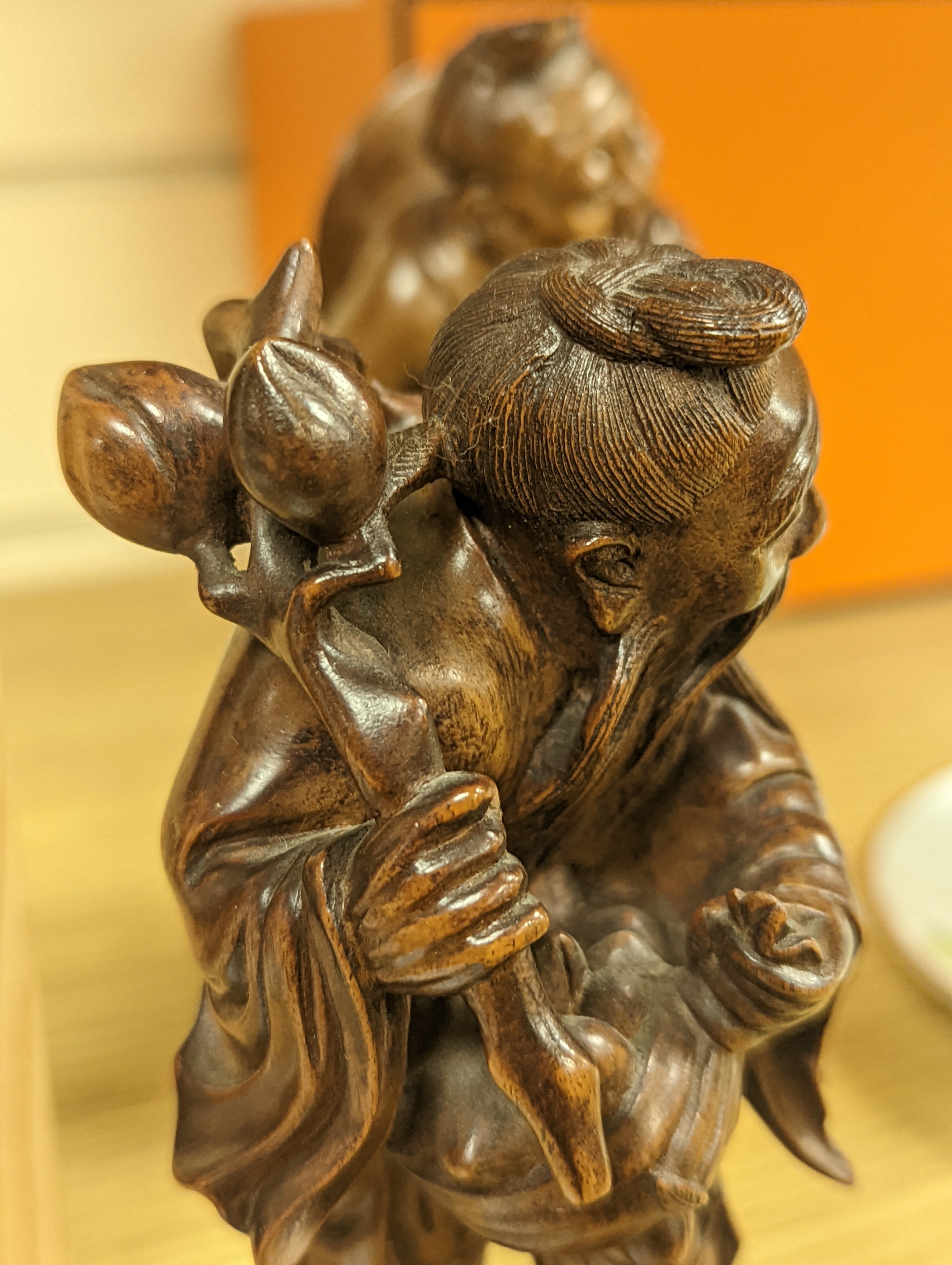 Two Chinese hardwood figures of a fisherman and a old man holding peaches 16cm